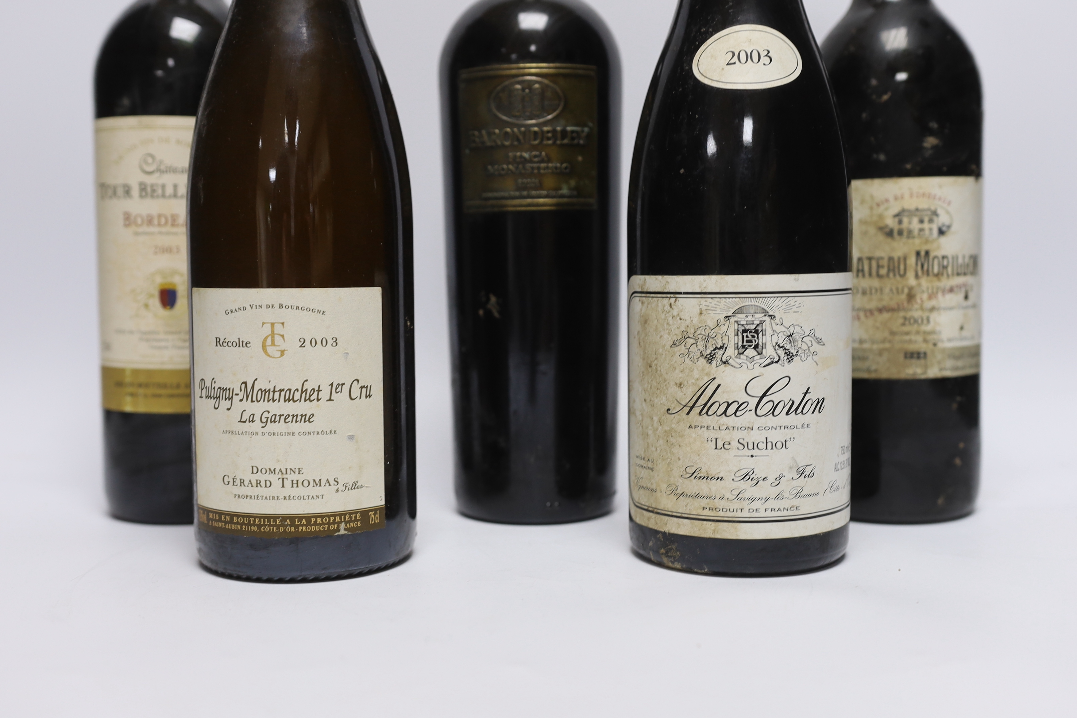 Six bottles of red wine - two bottles of Chateau Tour Bellegrave 2003, a bottle of Baron De Ley Rioja, a bottle of Simon Bize Aloxe Corton Le Suchot 2003, a bottle of Gérard Thomas Puligny-Montrachet La Garenne 2003 and